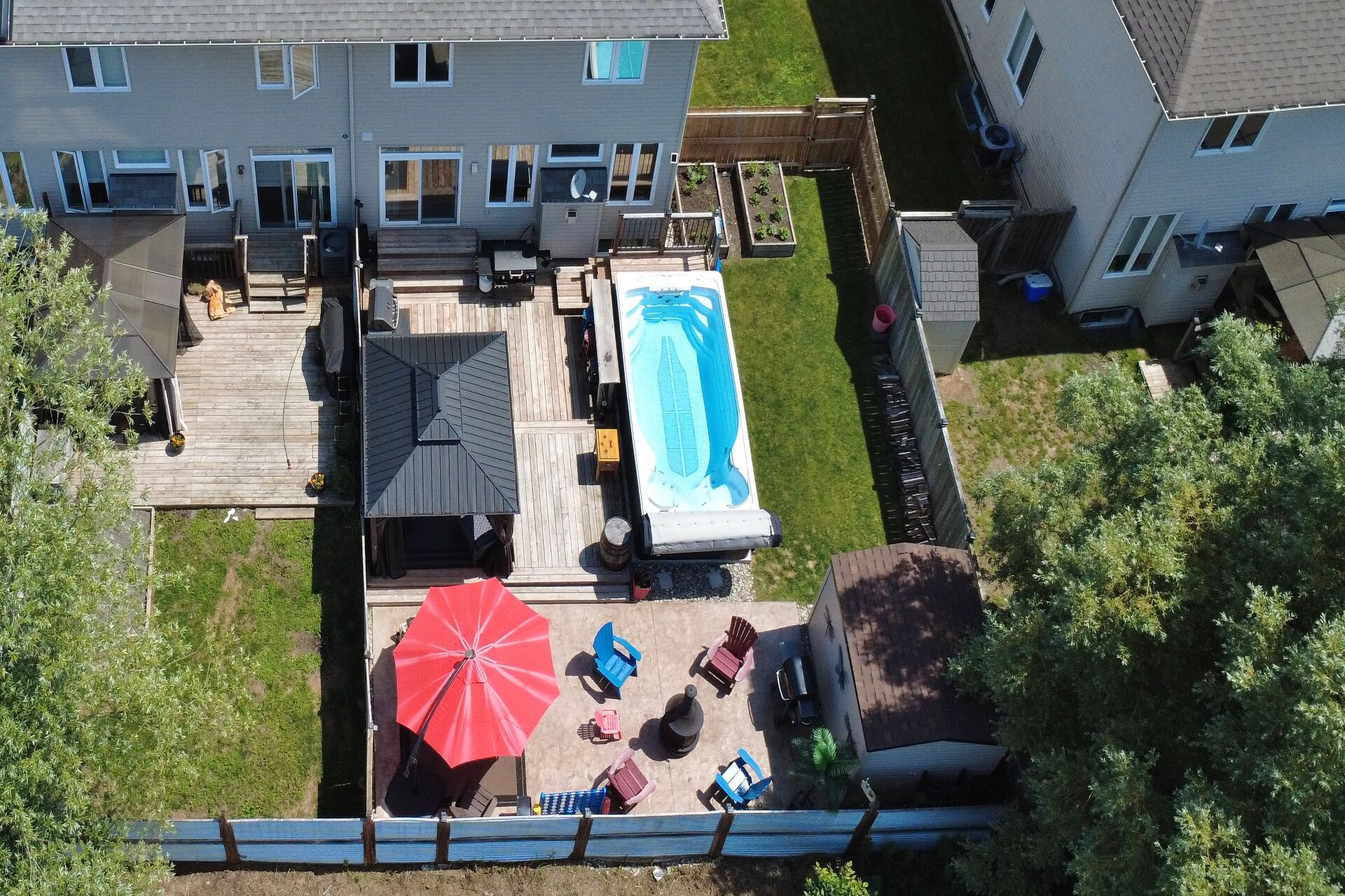 Aerial view of backyard with gazebo, patio and fire-pit area